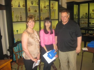 Melissa Phung receives her award, certificate and shirt from Diane Sahms-Guarnieri and Gary Martinez 